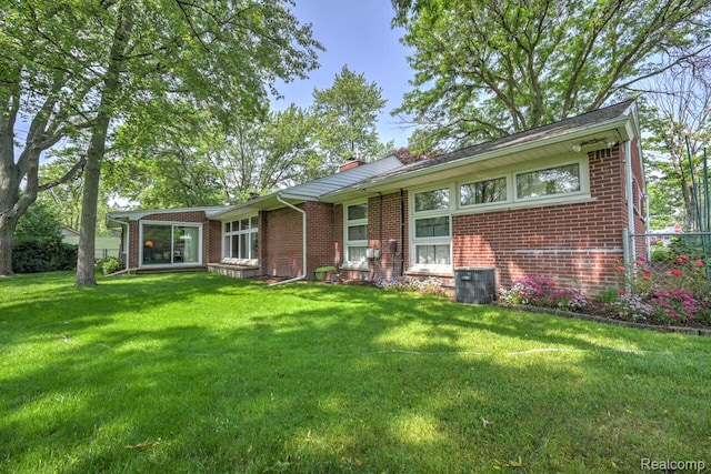 23880 Glencreek Dr, Farmington Hills, MI 48336 - view of front of house with brick siding, a front lawn, and a chimney
