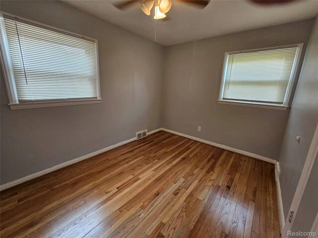 9311 Dixie, Redford, MI 48239 - empty room with a ceiling fan, hardwood / wood-style flooring, and healthy amount of natural light