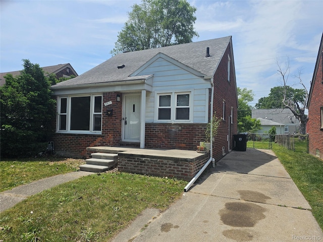 9311 Dixie, Redford, MI 48239 - bungalow-style house featuring brick siding, concrete driveway, and roof with shingles