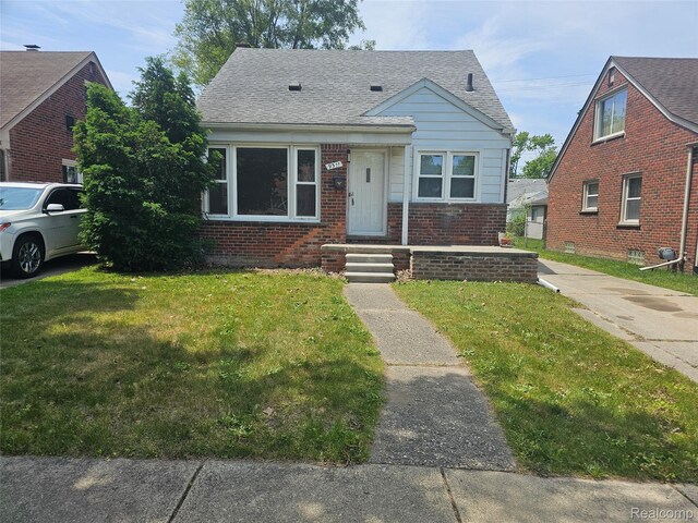 9311 Dixie, Redford, MI 48239 - bungalow-style house with brick siding, a front lawn, and a shingled roof