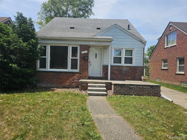 9311 Dixie, Redford, MI 48239 - bungalow-style home with brick siding, a front lawn, and roof with shingles