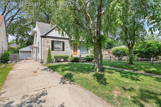 3156 Edgewood St, Dearborn, MI 48124 - view of front of property featuring stone siding, a garage, an outbuilding, and roof with shingles