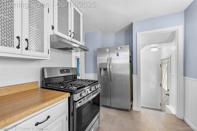 3156 Edgewood St, Dearborn, MI 48124 - kitchen featuring appliances with stainless steel finishes, under cabinet range hood, white cabinetry, light countertops, and tasteful backsplash