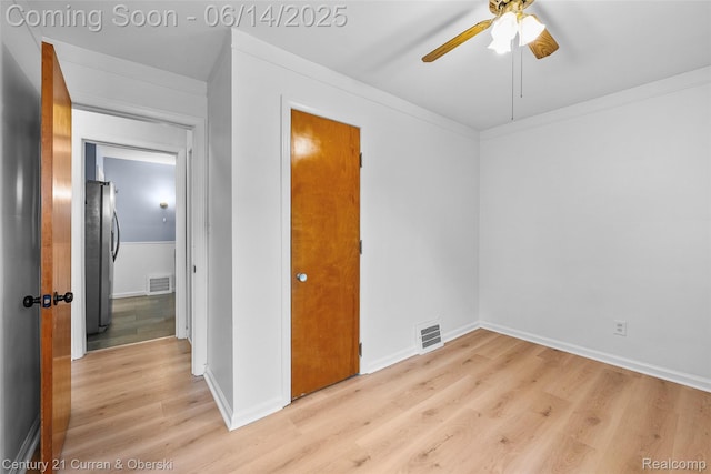 3156 Edgewood St, Dearborn, MI 48124 - unfurnished bedroom featuring freestanding refrigerator, light wood-type flooring, and a ceiling fan