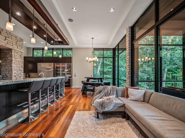 6956 Cooley Lake Rd, White Lake, MI 48383 - living room with a chandelier, wood finished floors, a raised ceiling, recessed lighting, and baseboards