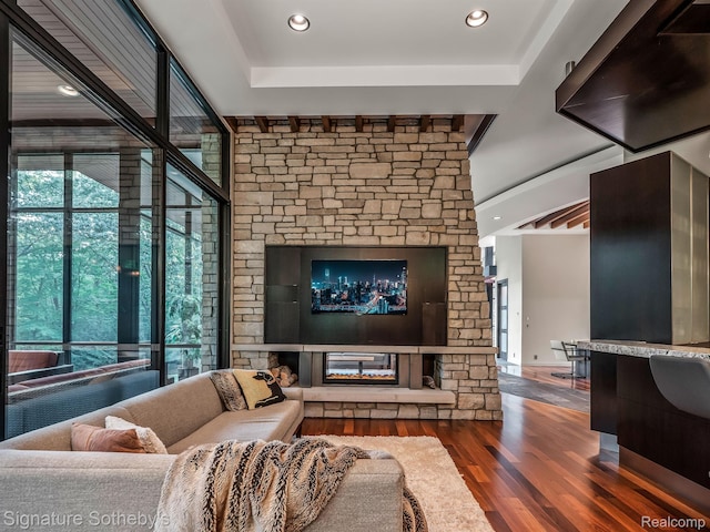6956 Cooley Lake Rd, White Lake, MI 48383 - living area with wood finished floors, a glass covered fireplace, and recessed lighting