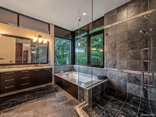 6956 Cooley Lake Rd, White Lake, MI 48383 - full bathroom featuring a tile shower, vanity, a bath, and stone tile flooring