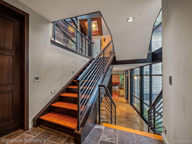 6956 Cooley Lake Rd, White Lake, MI 48383 - staircase featuring baseboards, plenty of natural light, recessed lighting, and expansive windows