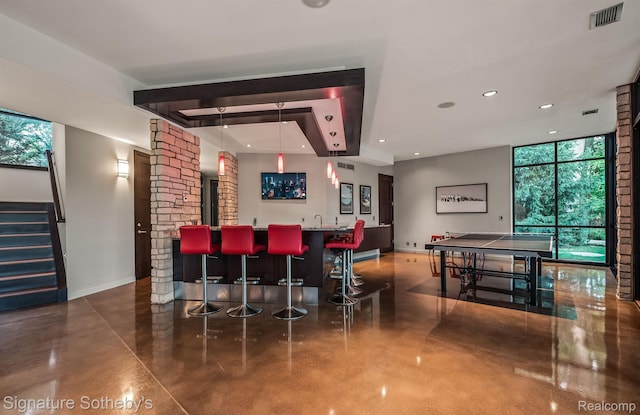 6956 Cooley Lake Rd, White Lake, MI 48383 - indoor wet bar with finished concrete flooring, baseboards, stairway, recessed lighting, and expansive windows