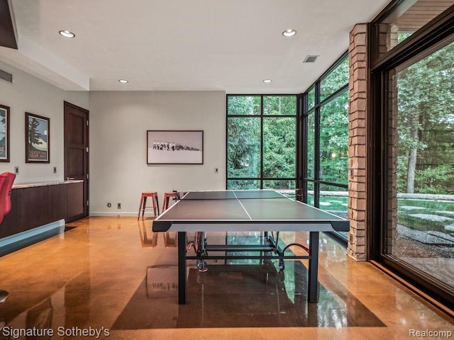 6956 Cooley Lake Rd, White Lake, MI 48383 - playroom with plenty of natural light, expansive windows, recessed lighting, finished concrete flooring, and baseboards