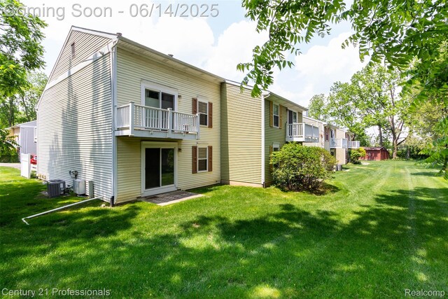 2024 Hamilton Rd Unit 6, Okemos, MI 48864 - rear view of property featuring central AC, a yard, and a balcony