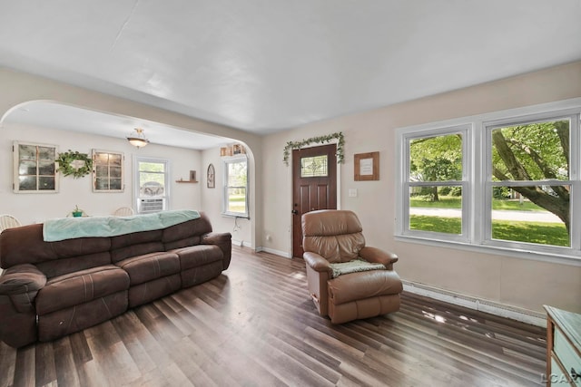 1028 Loren Rd, Adrian, MI 49221 - living room featuring arched walkways, wood finished floors, and baseboards