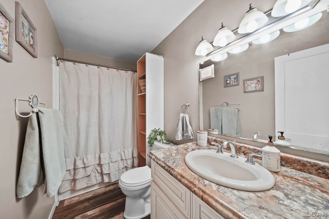 1028 Loren Rd, Adrian, MI 49221 - full bathroom featuring vanity, toilet, wood finished floors, and shower / tub combo with curtain