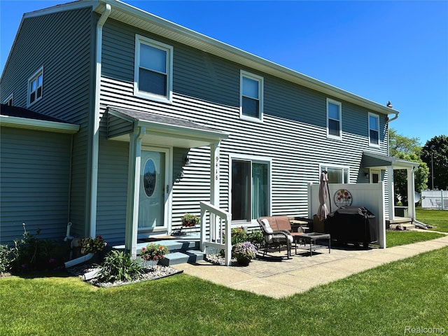 9418 Parkwood Dr N, Davison, MI 48423 - rear view of property with a lawn and a patio