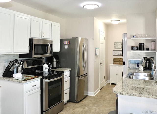 9418 Parkwood Dr N, Davison, MI 48423 - kitchen featuring appliances with stainless steel finishes, backsplash, white cabinets, and light stone countertops