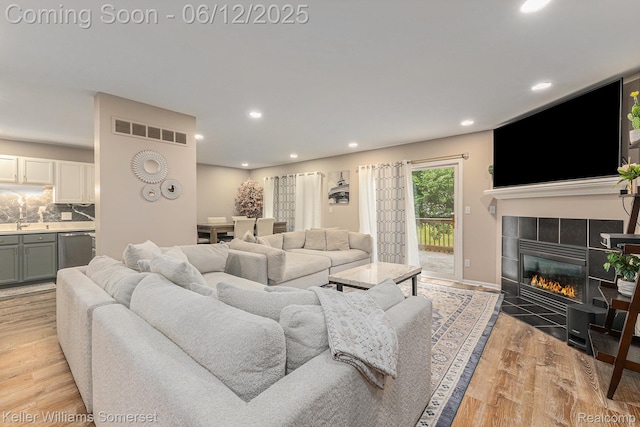 53242 Butternut St, Chesterfield, MI 48051 - living room with recessed lighting, a tile fireplace, and light wood-style floors