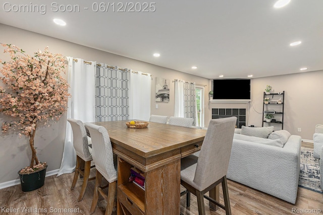 53242 Butternut St, Chesterfield, MI 48051 - dining space featuring wood finished floors, a tiled fireplace, recessed lighting, and baseboards