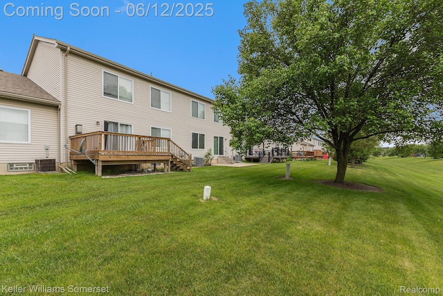 53242 Butternut St, Chesterfield, MI 48051 - rear view of property featuring a wooden deck, a lawn, and cooling unit