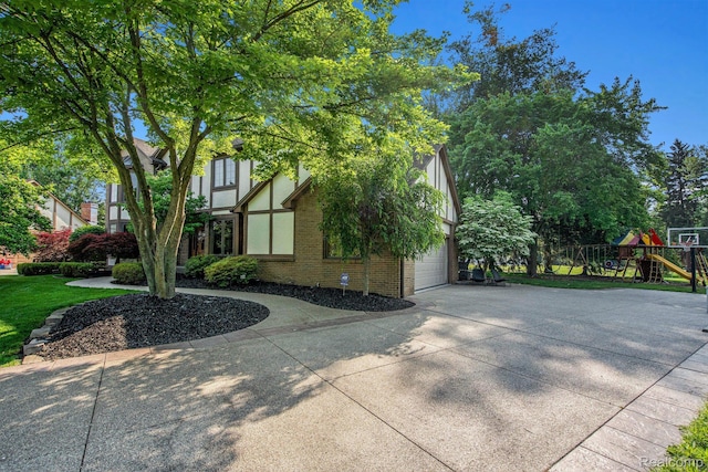 18704 Gary Ln, Livonia, MI 48152 - view of side of property with brick siding, driveway, and a playground