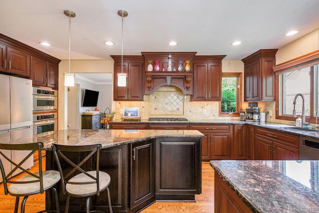 18704 Gary Ln, Livonia, MI 48152 - kitchen with appliances with stainless steel finishes, light wood-style floors, recessed lighting, dark stone counters, and tasteful backsplash