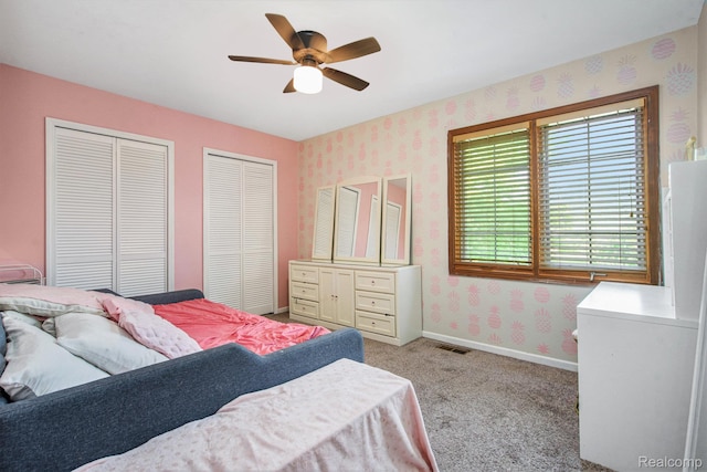 18704 Gary Ln, Livonia, MI 48152 - bedroom with wallpapered walls, two closets, light carpet, and ceiling fan