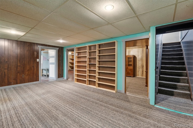 15356 Hampden St, Taylor, MI 48180 - finished basement with carpet, stairs, a paneled ceiling, and wood walls