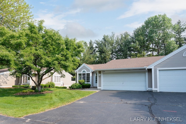 569 Appletree Dr, Holland, MI 49423 - view of front of house with a front lawn, driveway, and an attached garage