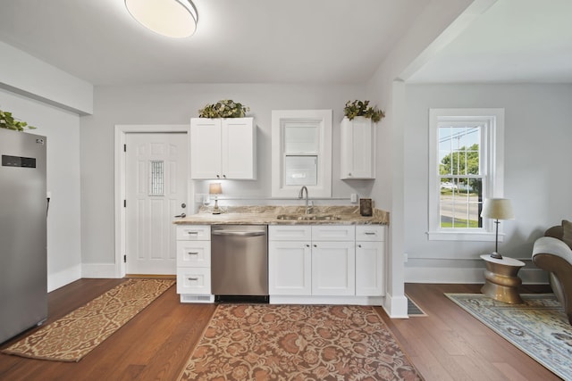 911 E Ganson St, Jackson, MI 49201 - kitchen featuring stainless steel appliances, a sink, dark wood-style flooring, and baseboards