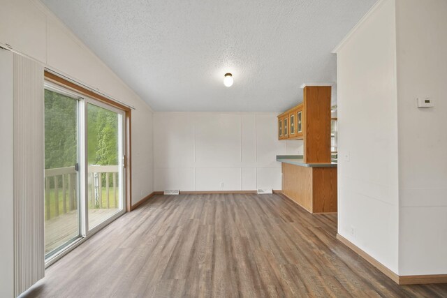 948 Savannah River Dr, Adrian, MI 49221 - unfurnished living room with a textured ceiling, wood finished floors, and baseboards