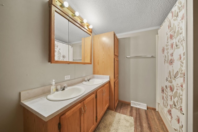 948 Savannah River Dr, Adrian, MI 49221 - full bath with double vanity, wood finished floors, a textured ceiling, crown molding, and baseboards