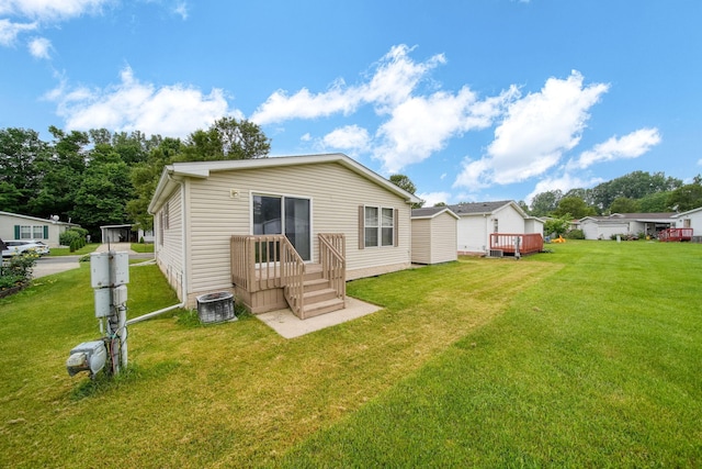 948 Savannah River Dr, Adrian, MI 49221 - rear view of house featuring a yard and central AC