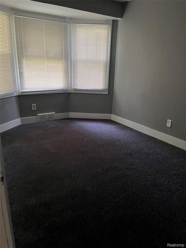 4150 Woodhall St, Detroit, MI 48224 - unfurnished room with dark carpet and baseboards