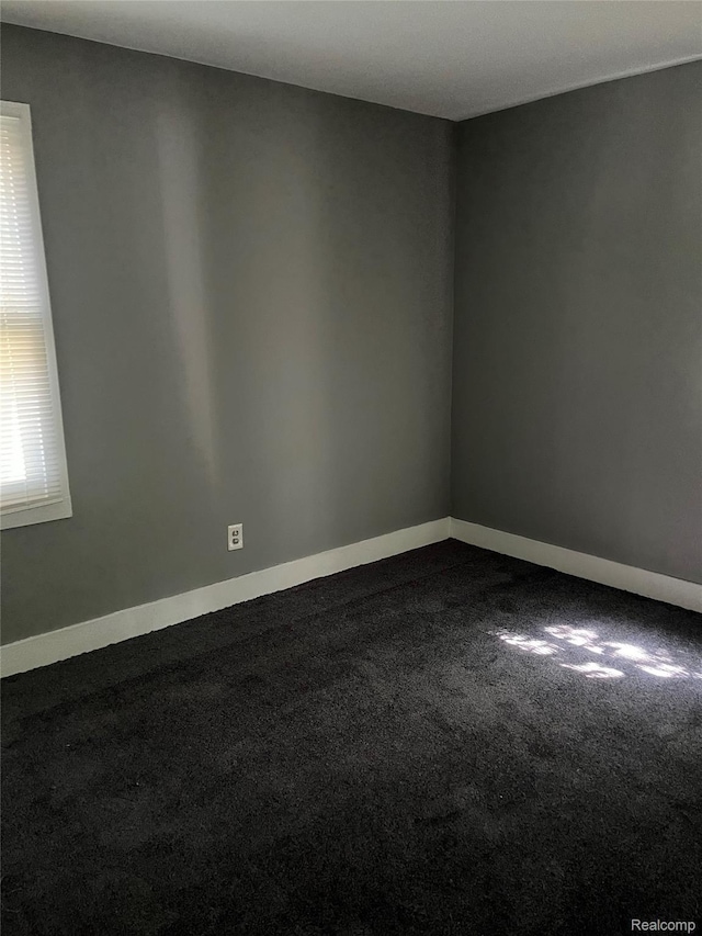 4150 Woodhall St, Detroit, MI 48224 - empty room with dark carpet and baseboards
