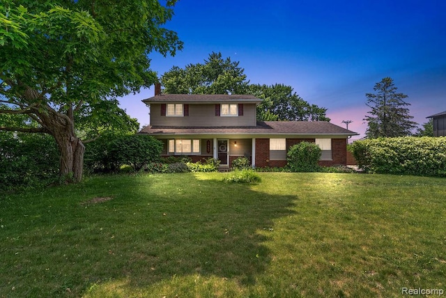 5445 Frankwill Ave, Clarkston, MI 48346 - traditional-style home with a chimney, a yard, and brick siding