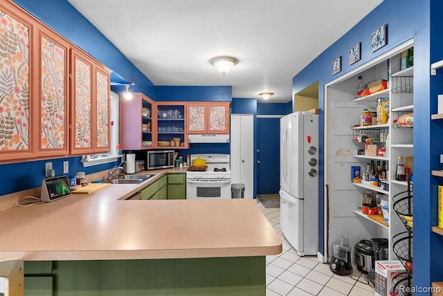 5445 Frankwill Ave, Clarkston, MI 48346 - kitchen with white appliances, under cabinet range hood, light tile patterned floors, a peninsula, and light countertops