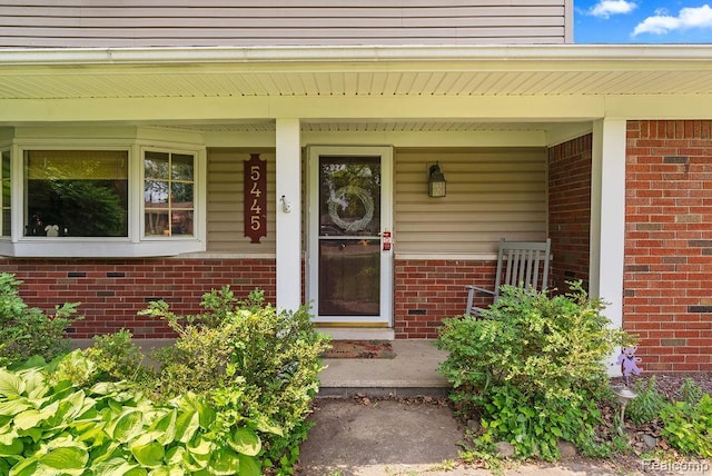5445 Frankwill Ave, Clarkston, MI 48346 - doorway to property with covered porch and brick siding