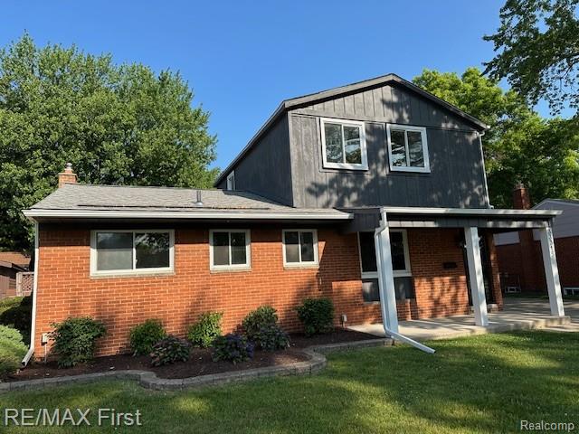 33315 Vista Way, Fraser, MI 48026 - back of house with brick siding, a lawn, a patio, and a chimney