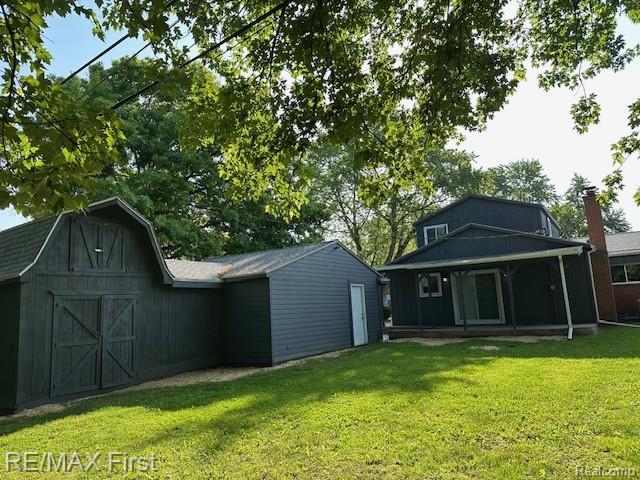 33315 Vista Way, Fraser, MI 48026 - back of property with a barn, a lawn, and an outdoor structure