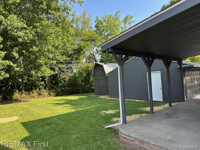 33315 Vista Way, Fraser, MI 48026 - view of grassy yard with a garage