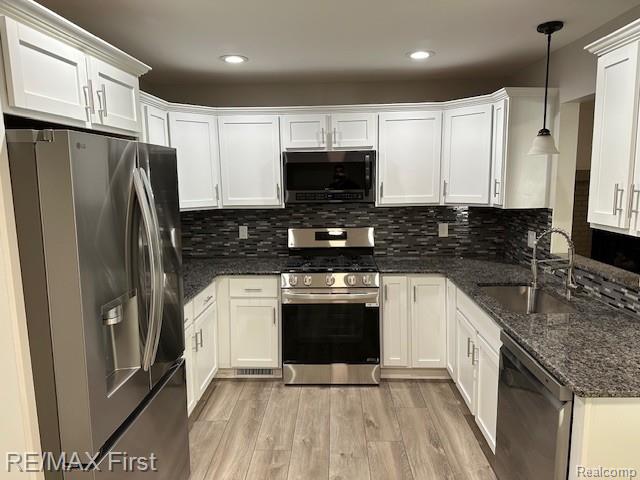 33315 Vista Way, Fraser, MI 48026 - kitchen with appliances with stainless steel finishes, a sink, white cabinetry, light wood finished floors, and recessed lighting