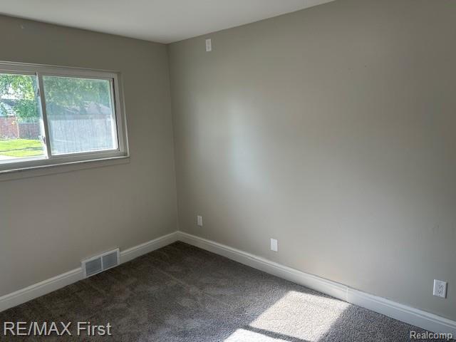 33315 Vista Way, Fraser, MI 48026 - spare room featuring dark carpet and baseboards