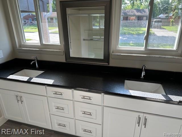 33315 Vista Way, Fraser, MI 48026 - kitchen with a sink, dark countertops, and white cabinetry