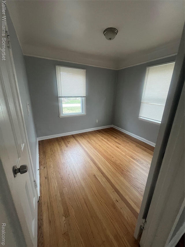 22005 Rausch Ave, Eastpointe, MI 48021 - empty room featuring wood finished floors, crown molding, and baseboards
