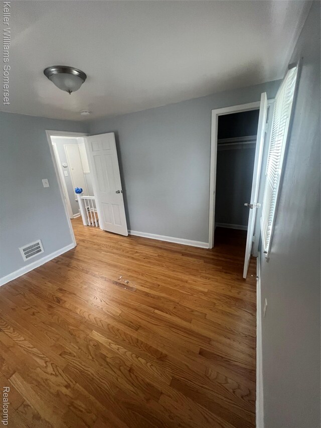 22005 Rausch Ave, Eastpointe, MI 48021 - unfurnished bedroom featuring baseboards, wood finished floors, and a closet