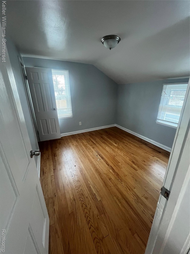 22005 Rausch Ave, Eastpointe, MI 48021 - unfurnished bedroom with vaulted ceiling, wood finished floors, and baseboards