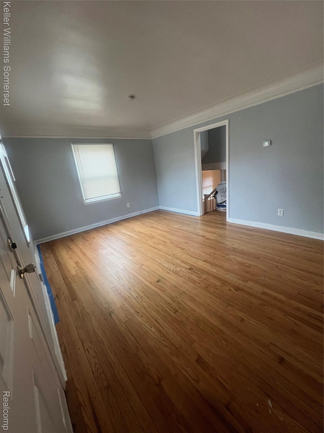 22005 Rausch Ave, Eastpointe, MI 48021 - unfurnished room with crown molding, light wood-style floors, and baseboards