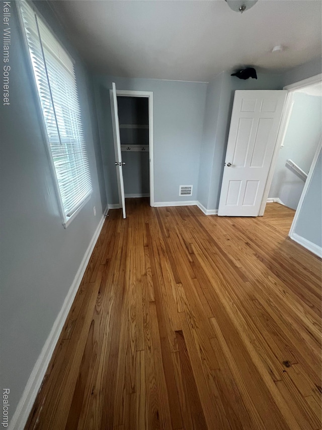 22005 Rausch Ave, Eastpointe, MI 48021 - unfurnished bedroom with baseboards, wood finished floors, and a closet
