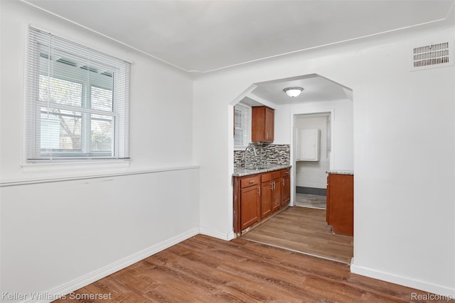 22005 Rausch Ave, Eastpointe, MI 48021 - kitchen featuring wood finished floors, baseboards, brown cabinetry, and a sink