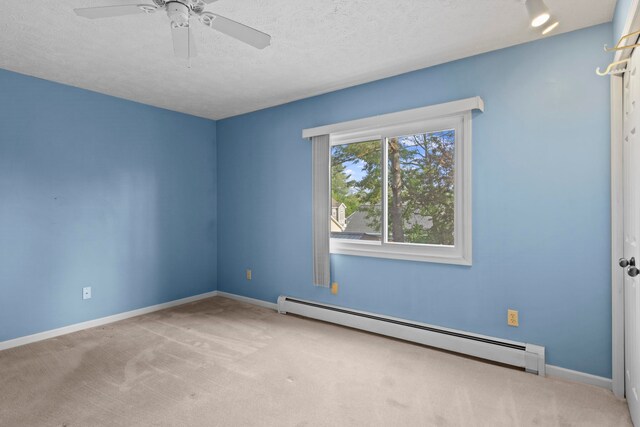 515 Georgetown Dr, Traverse City, MI 49684 - empty room featuring baseboard heating, carpet flooring, ceiling fan, baseboards, and a textured ceiling