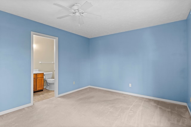 515 Georgetown Dr, Traverse City, MI 49684 - empty room featuring light carpet, baseboards, and a ceiling fan